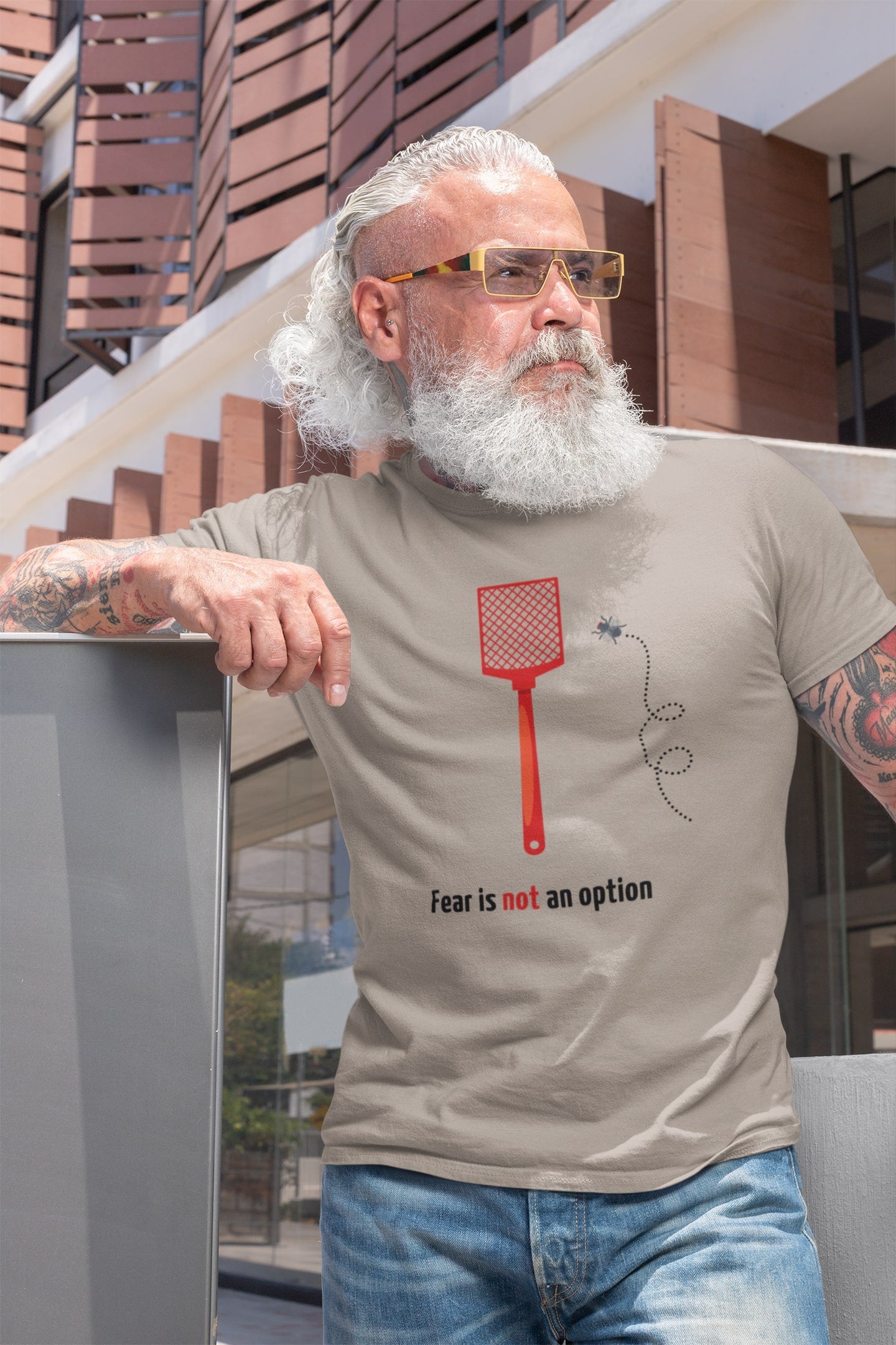 "Fear is not an option". Grappig shirt met een dappere vlieg die het opneemt tegen een vliegenmepper. 100% biologisch katoen. Kleur: Desert Dust